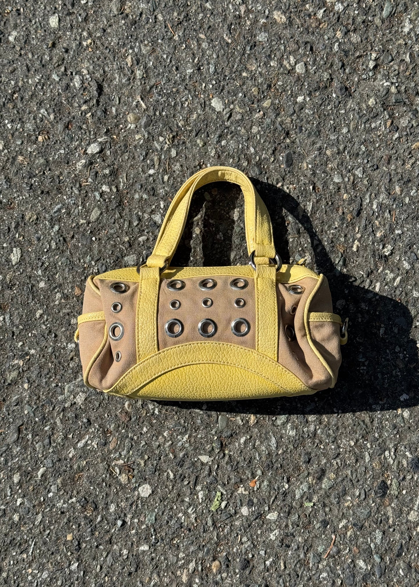 yellow grommet handbag