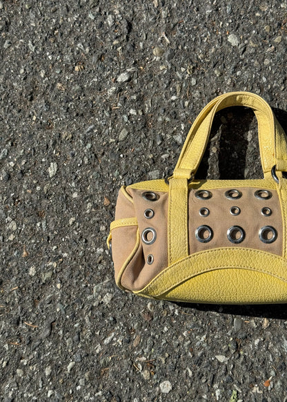 yellow grommet handbag
